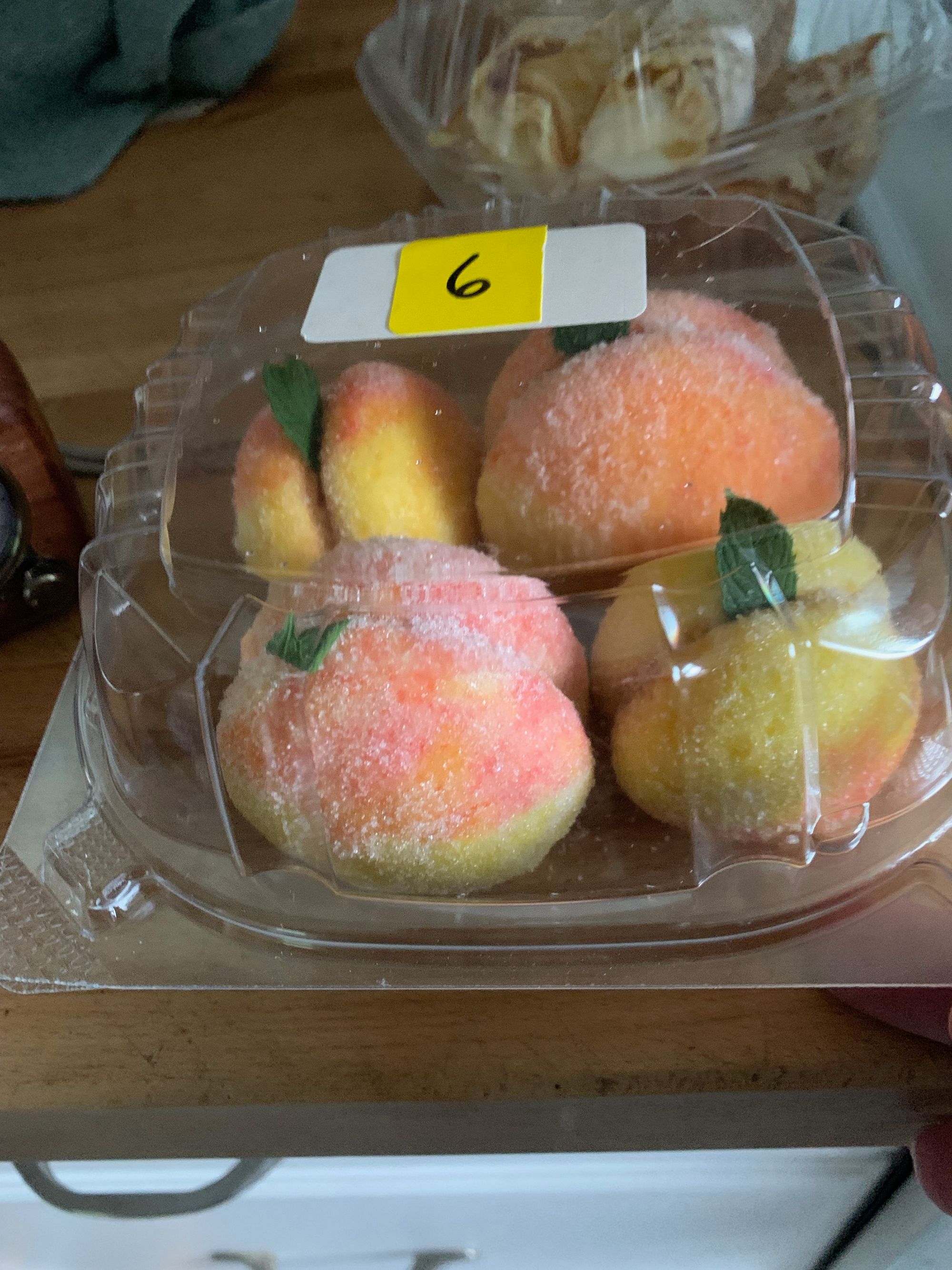 cakes shaped like a peach in a plastic clamshell