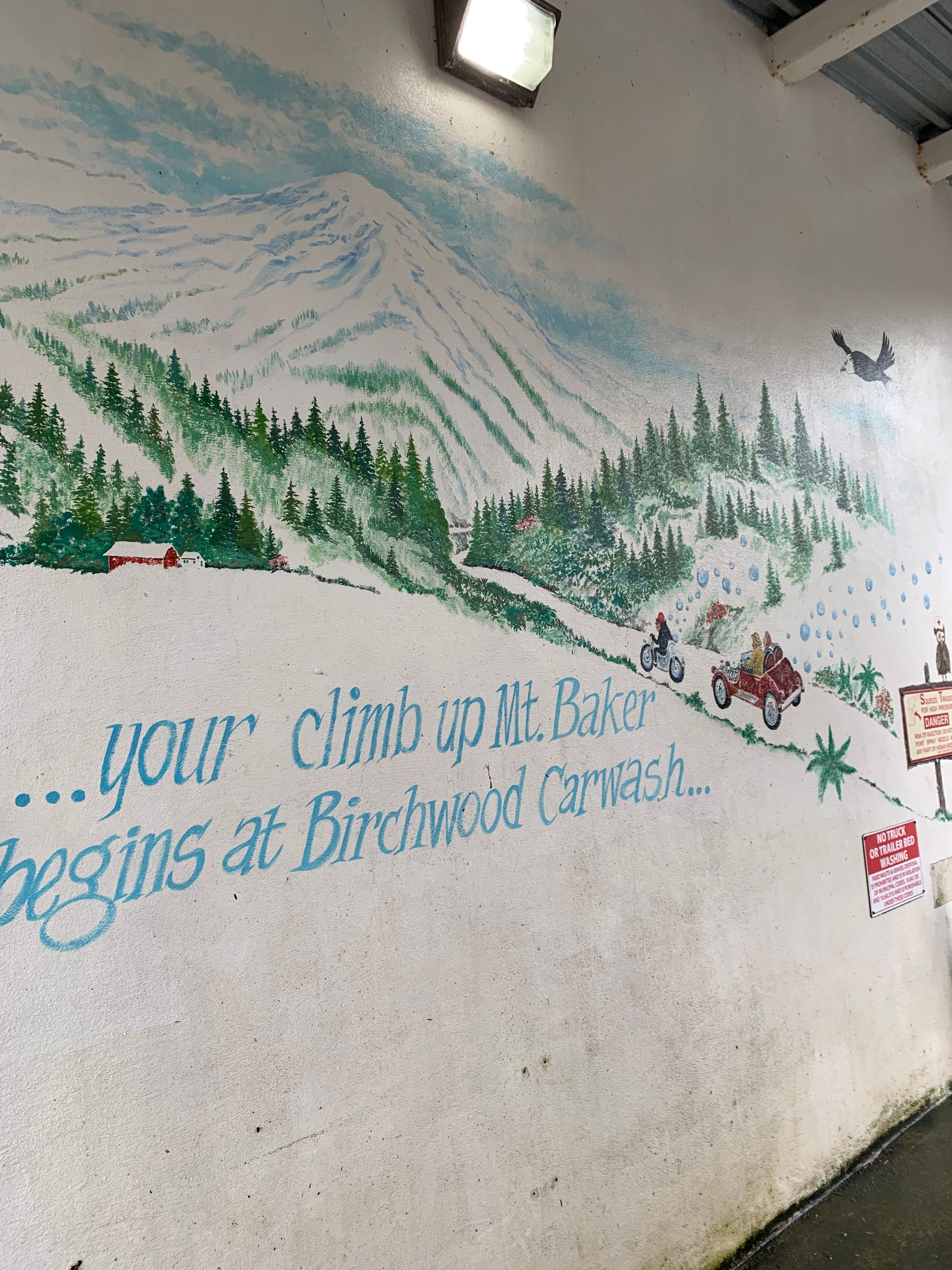 mural of a mountain road on a carwash wall