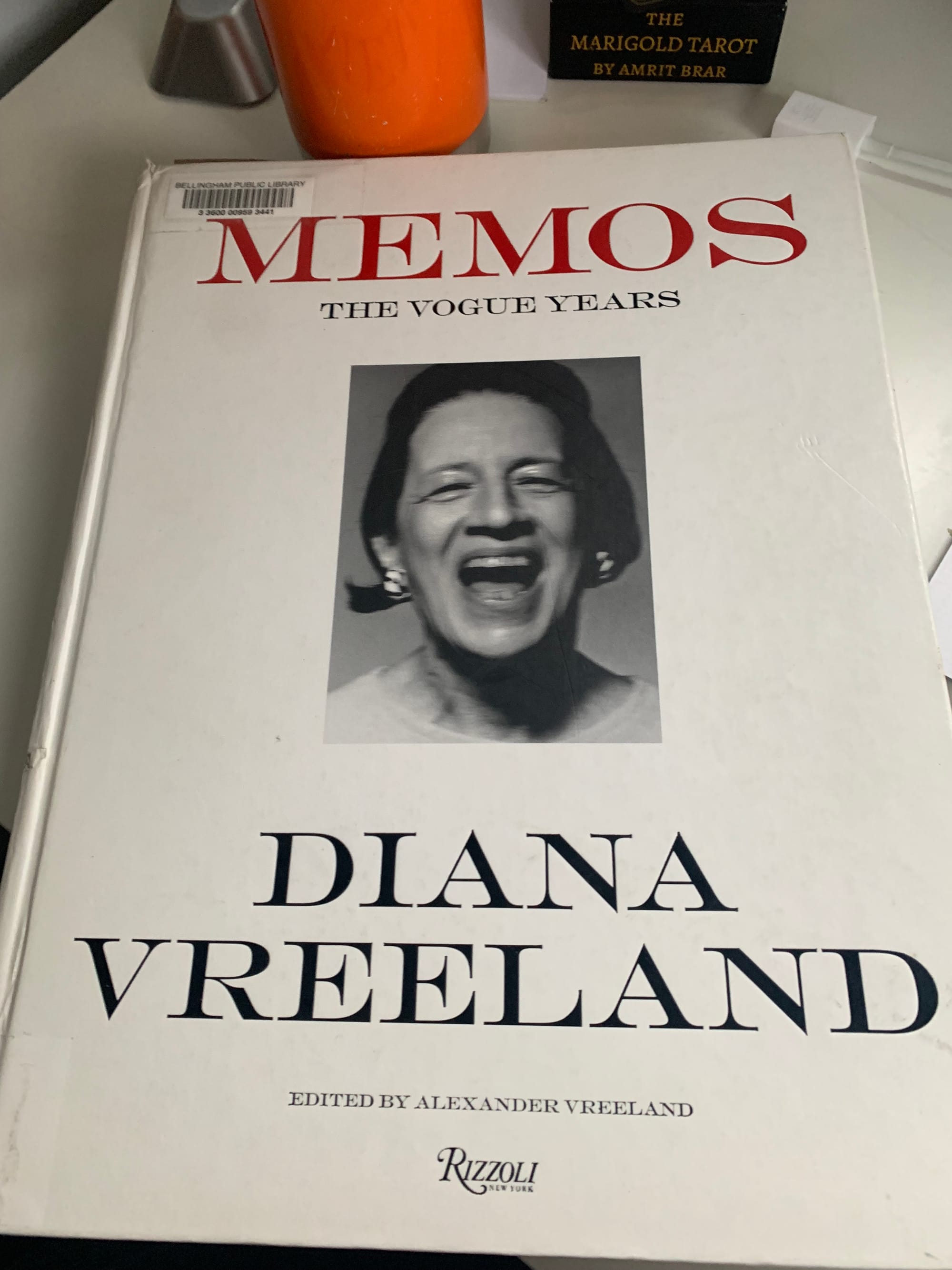 the cover of Diana Vreeland's Memos, a large white book with a black & white photo of a woman laughing