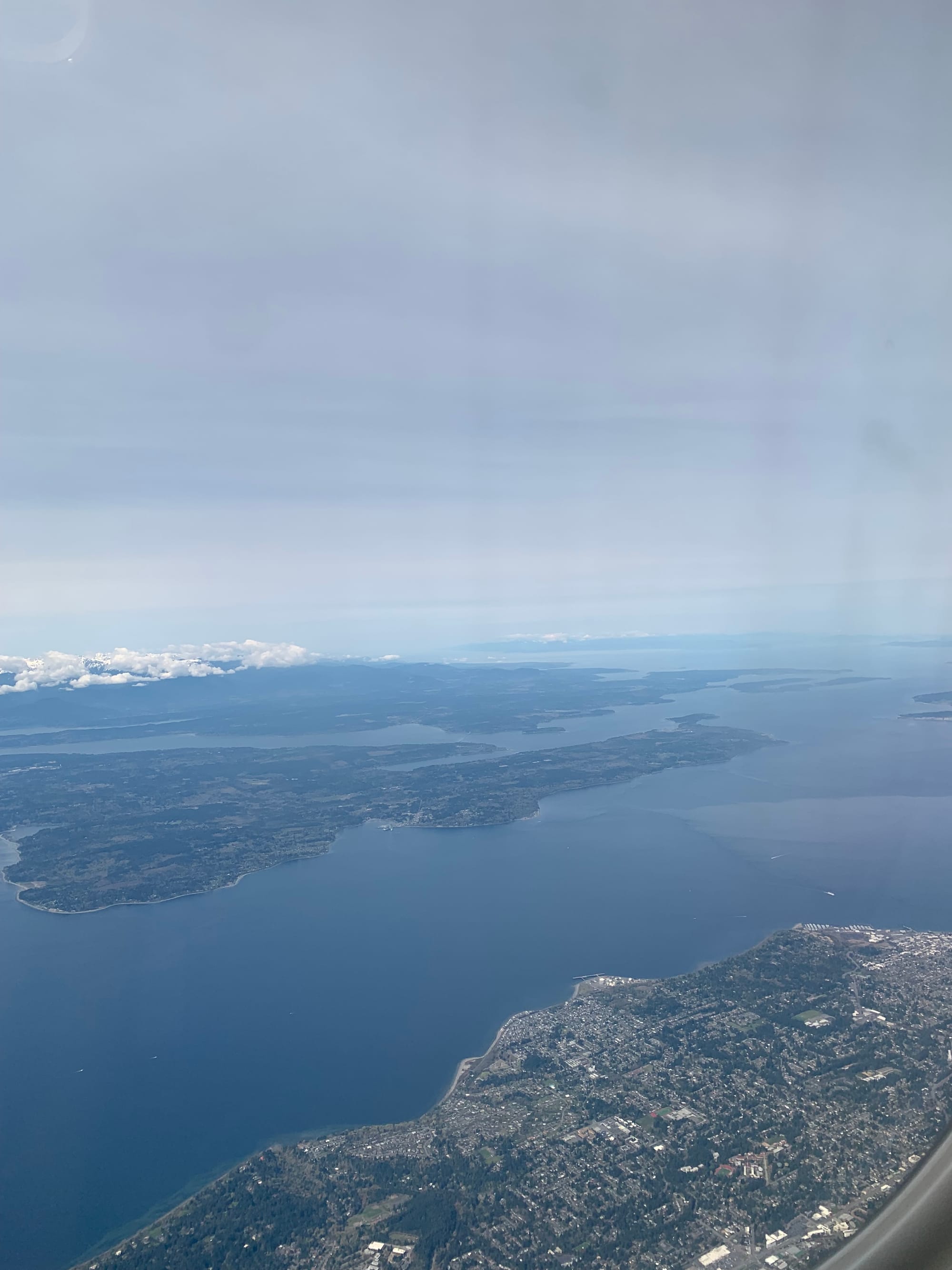 view from an airplane, islands & bay & white clouds